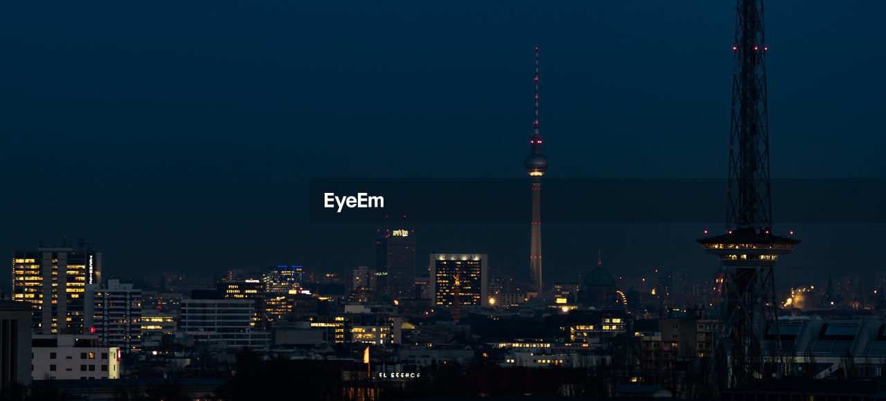 Aerial view of city lit up at night