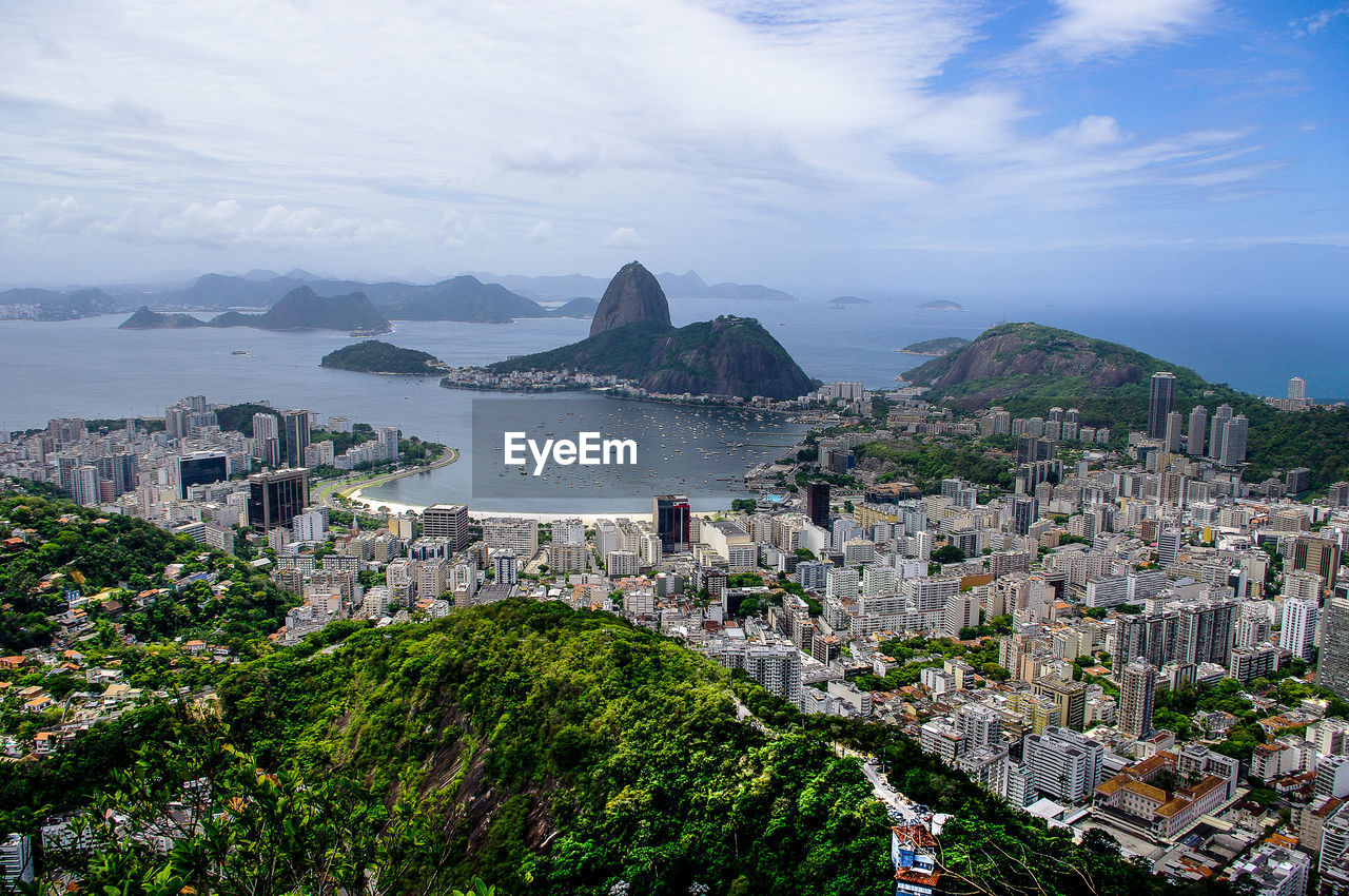 Sugarloaf mountain and cityscape by sea against sky
