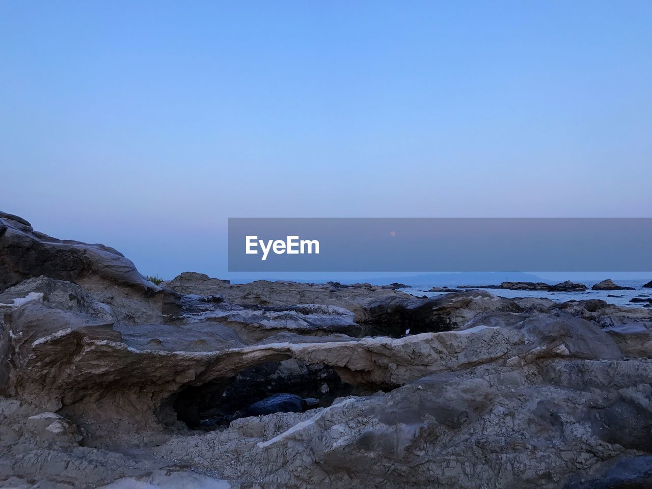 Scenic view of water against clear sky