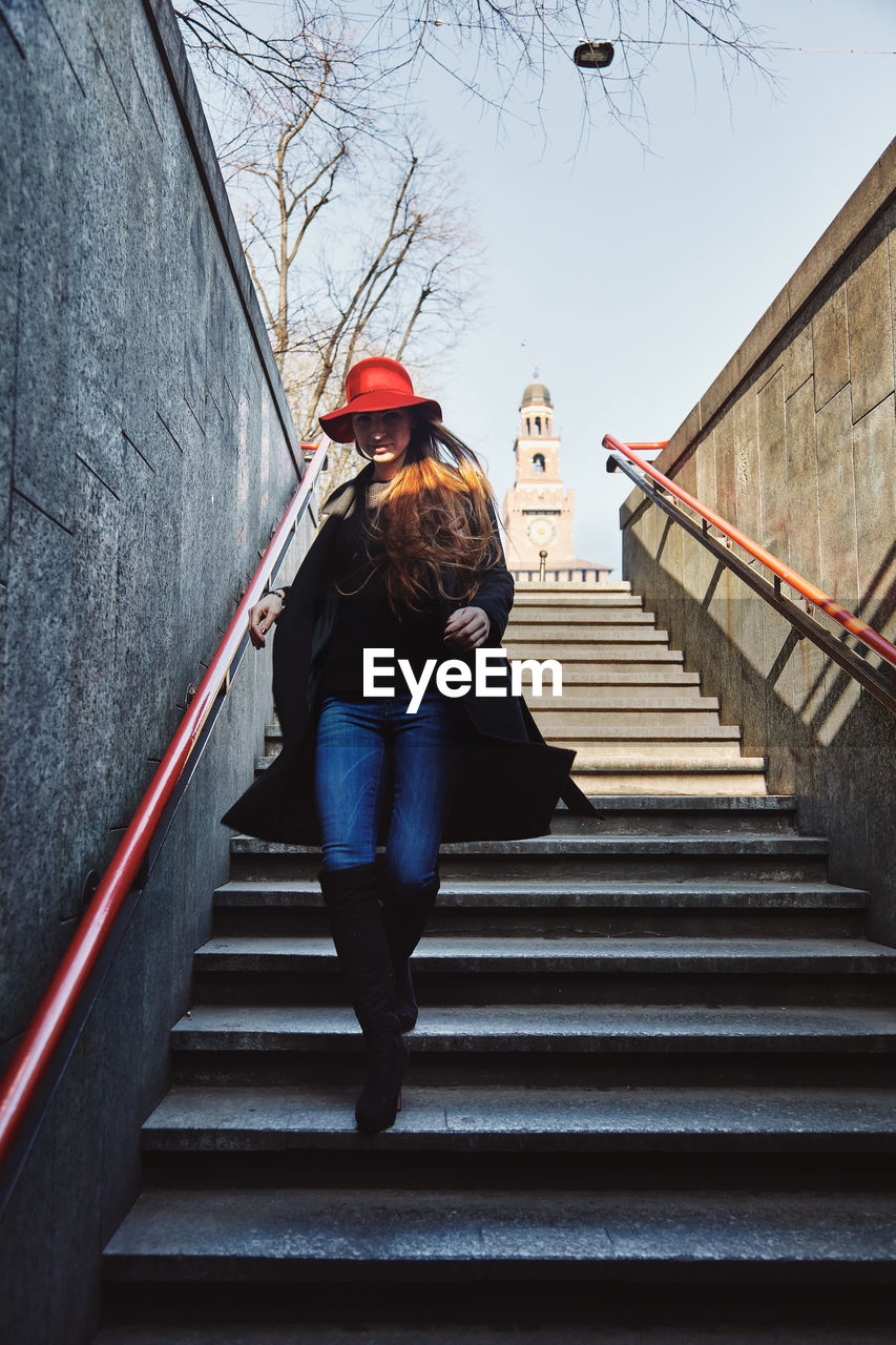 Full length of woman walking down on staircase