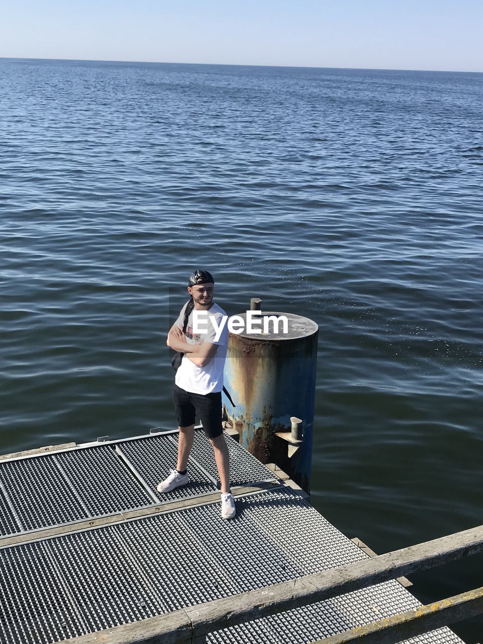 PORTRAIT OF YOUNG MAN STANDING IN SEA