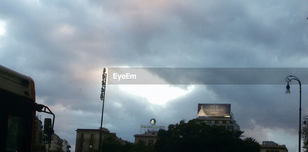 LOW ANGLE VIEW OF BUILDINGS AGAINST CLOUDY SKY