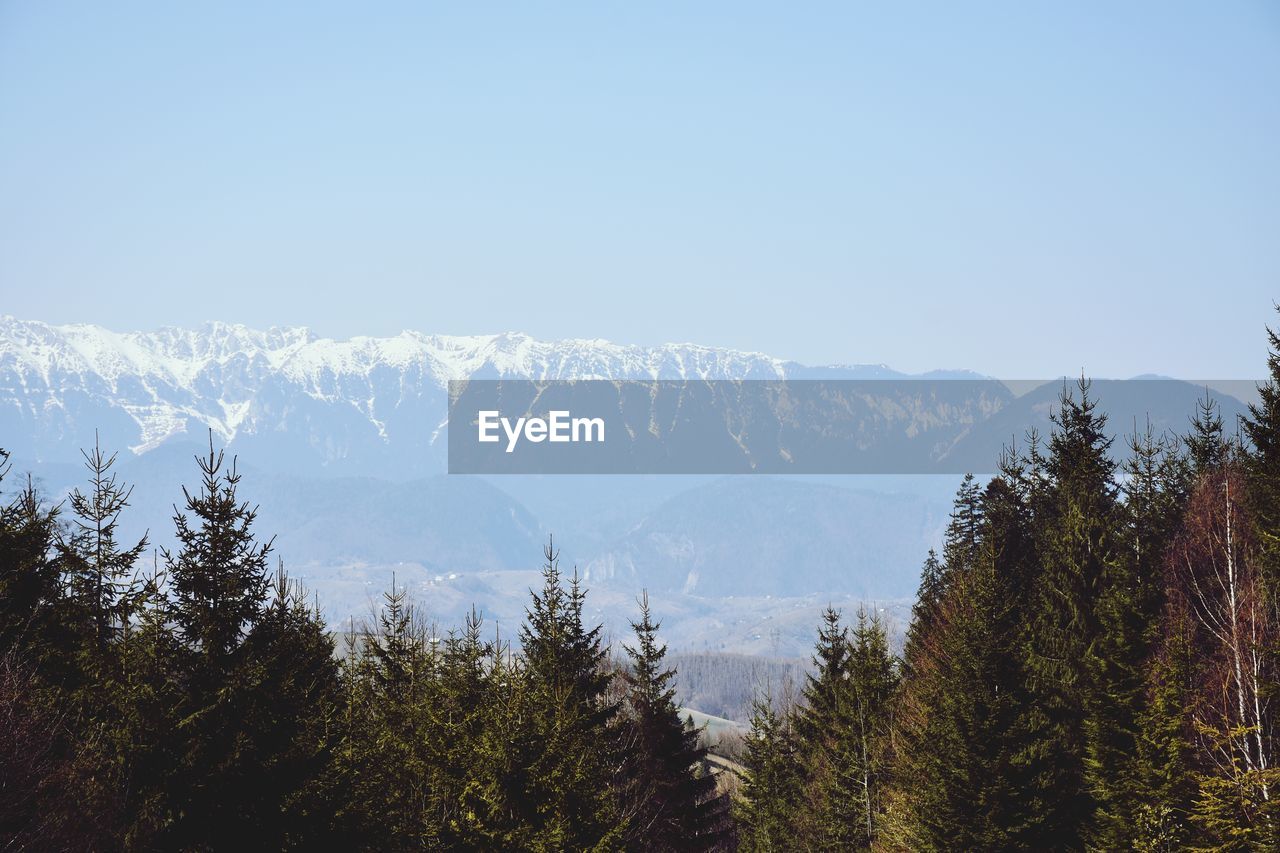 Scenic view of snowcapped mountains against clear sky