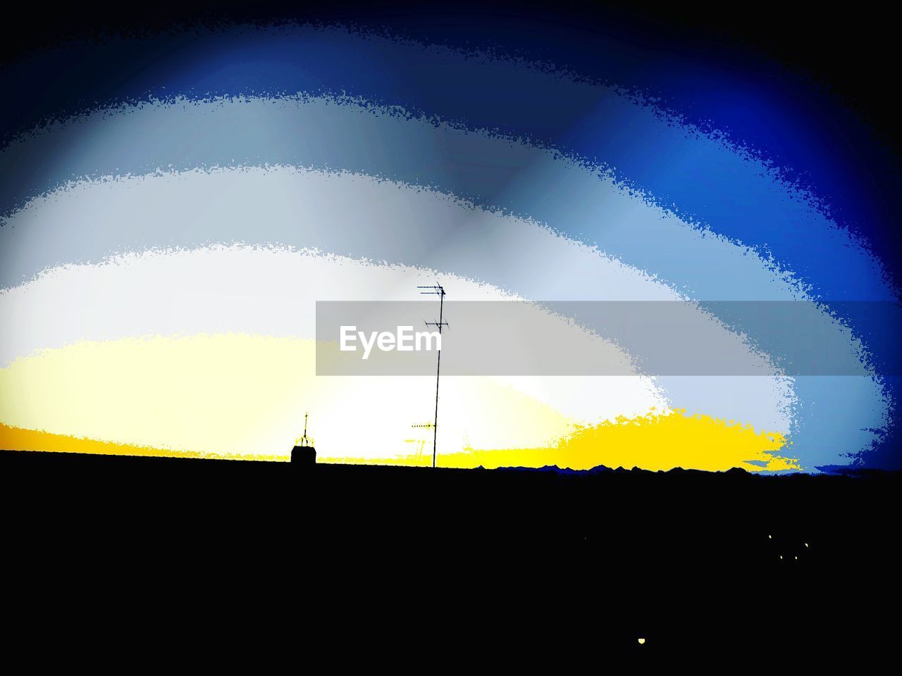 Digital composite image of television aerial on silhouette roof