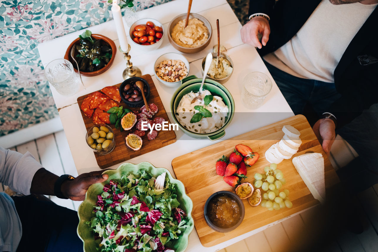 Directly above shot of friends having healthy food at table