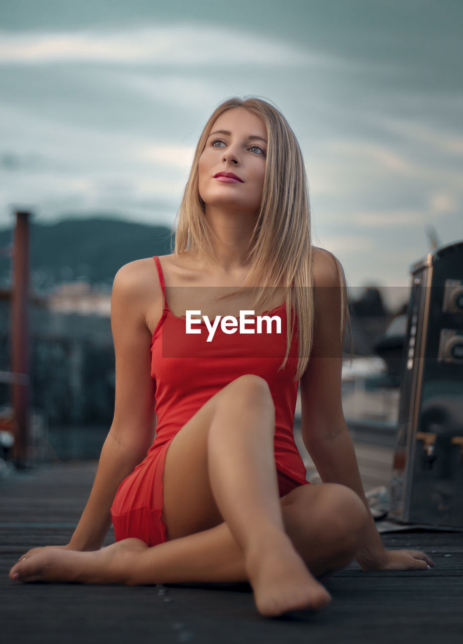 Portrait of young woman sitting on terrace