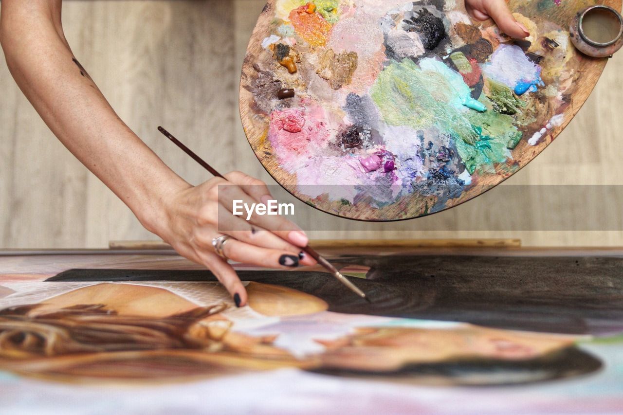 Cropped image of woman painting at studio