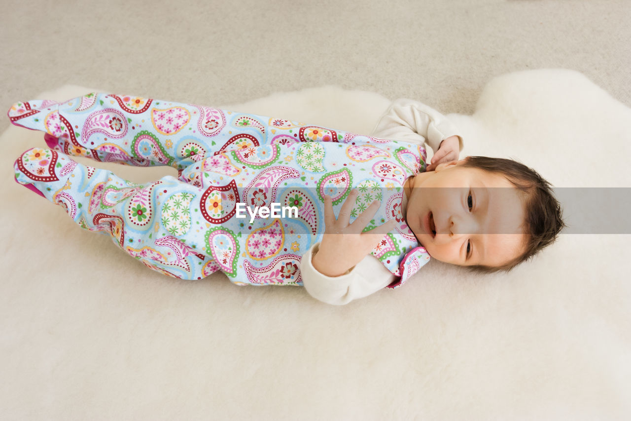 High angle view of cute baby girl sleeping on bed