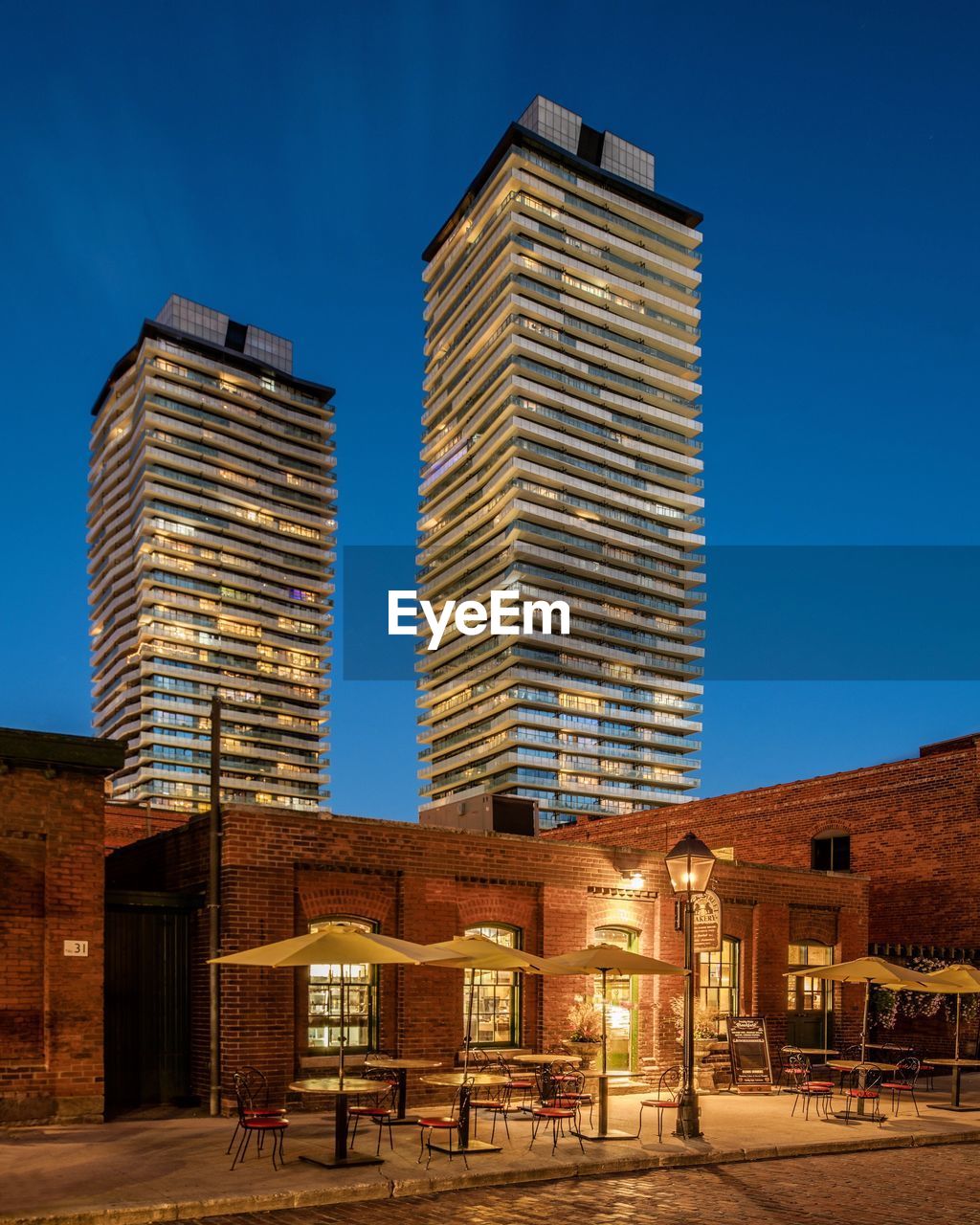 Buildings in city against blue sky during dusk