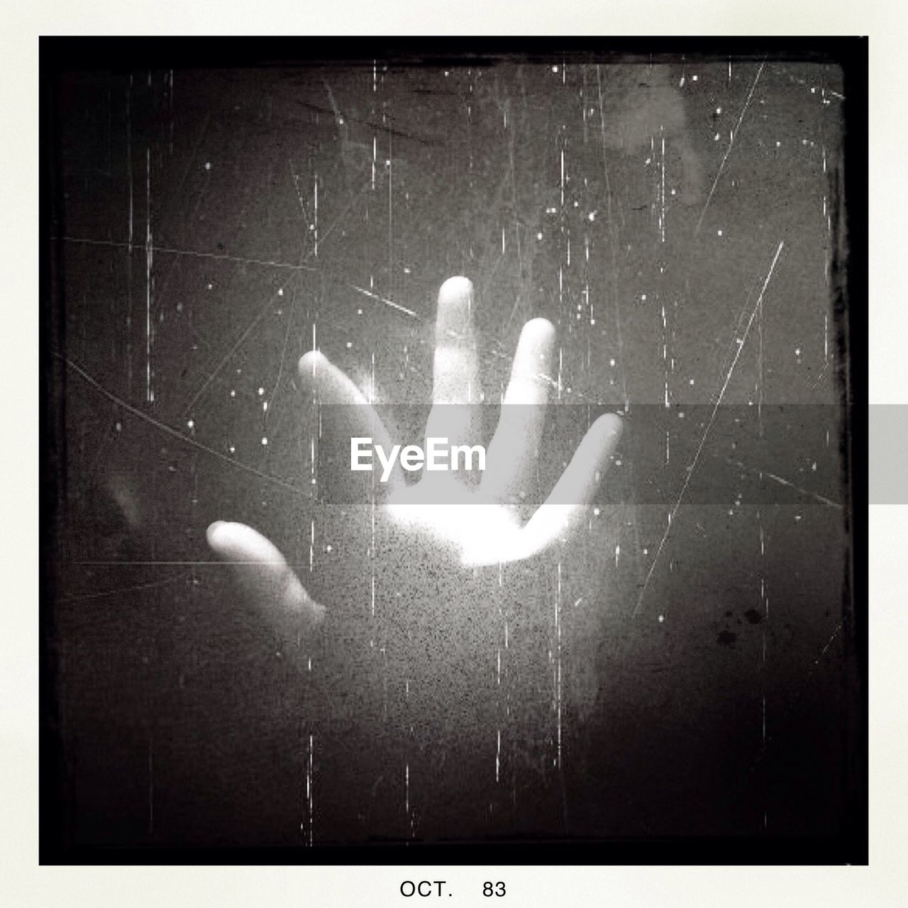 Close-up of hand on glass