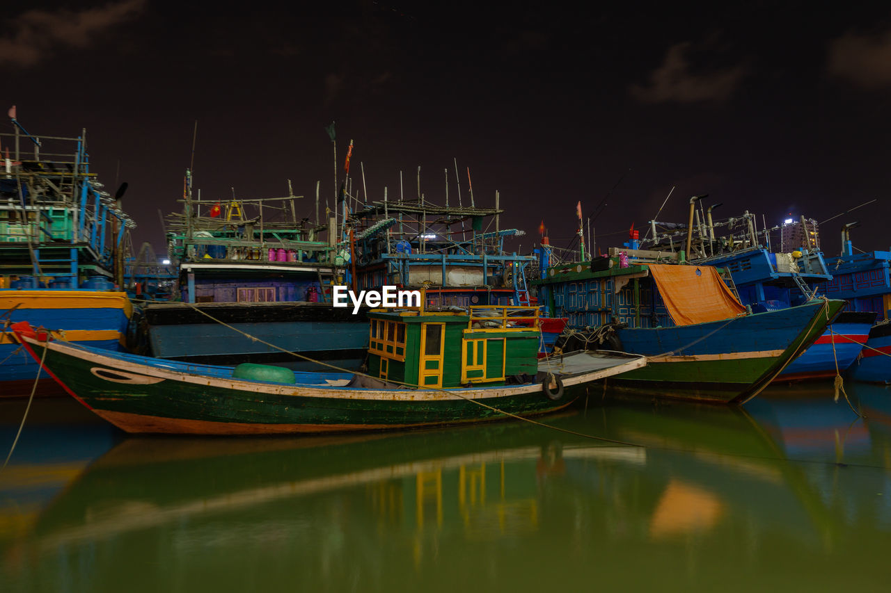 BOATS MOORED IN HARBOR