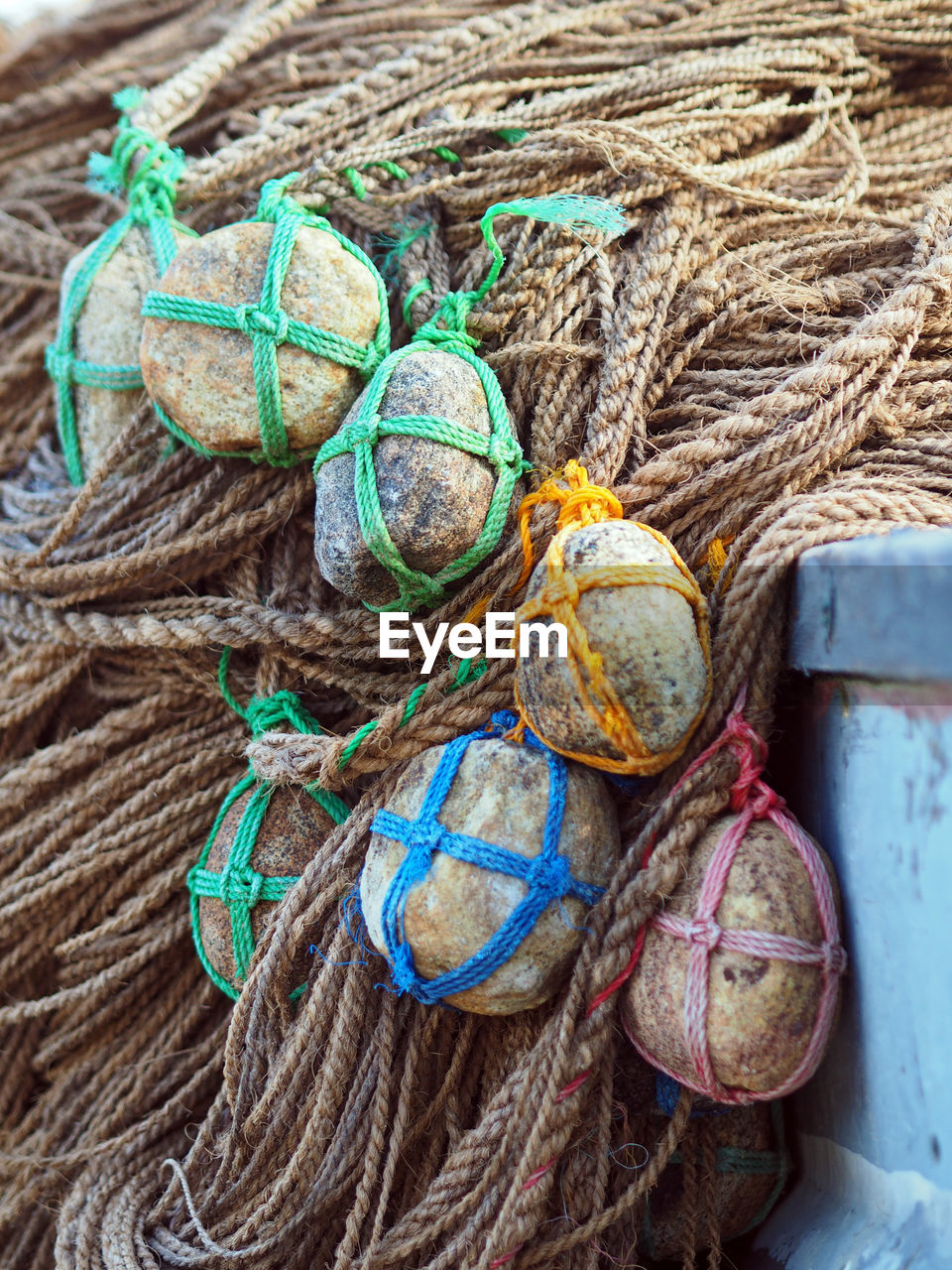 Pile of stones tied on ropes in boat