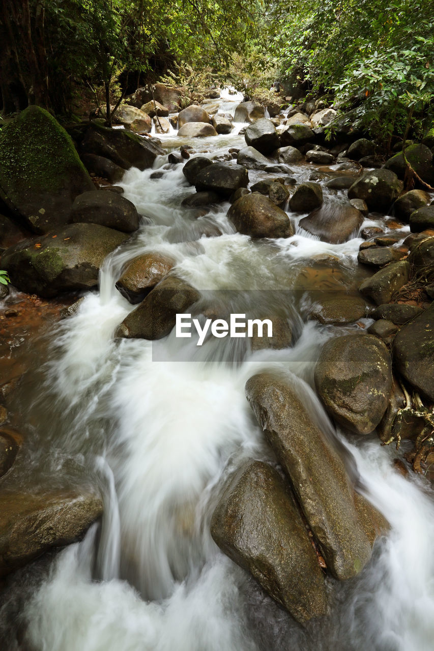 VIEW OF STREAM FLOWING THROUGH ROCKS