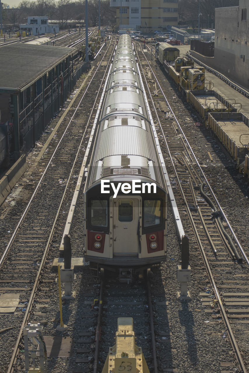 HIGH ANGLE VIEW OF TRAIN ON RAILROAD STATION PLATFORM