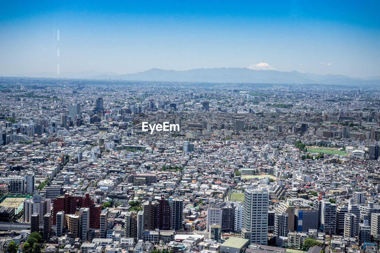 High angle view of modern buildings in city against sky