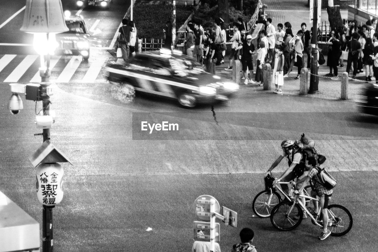 People on illuminated city street at night