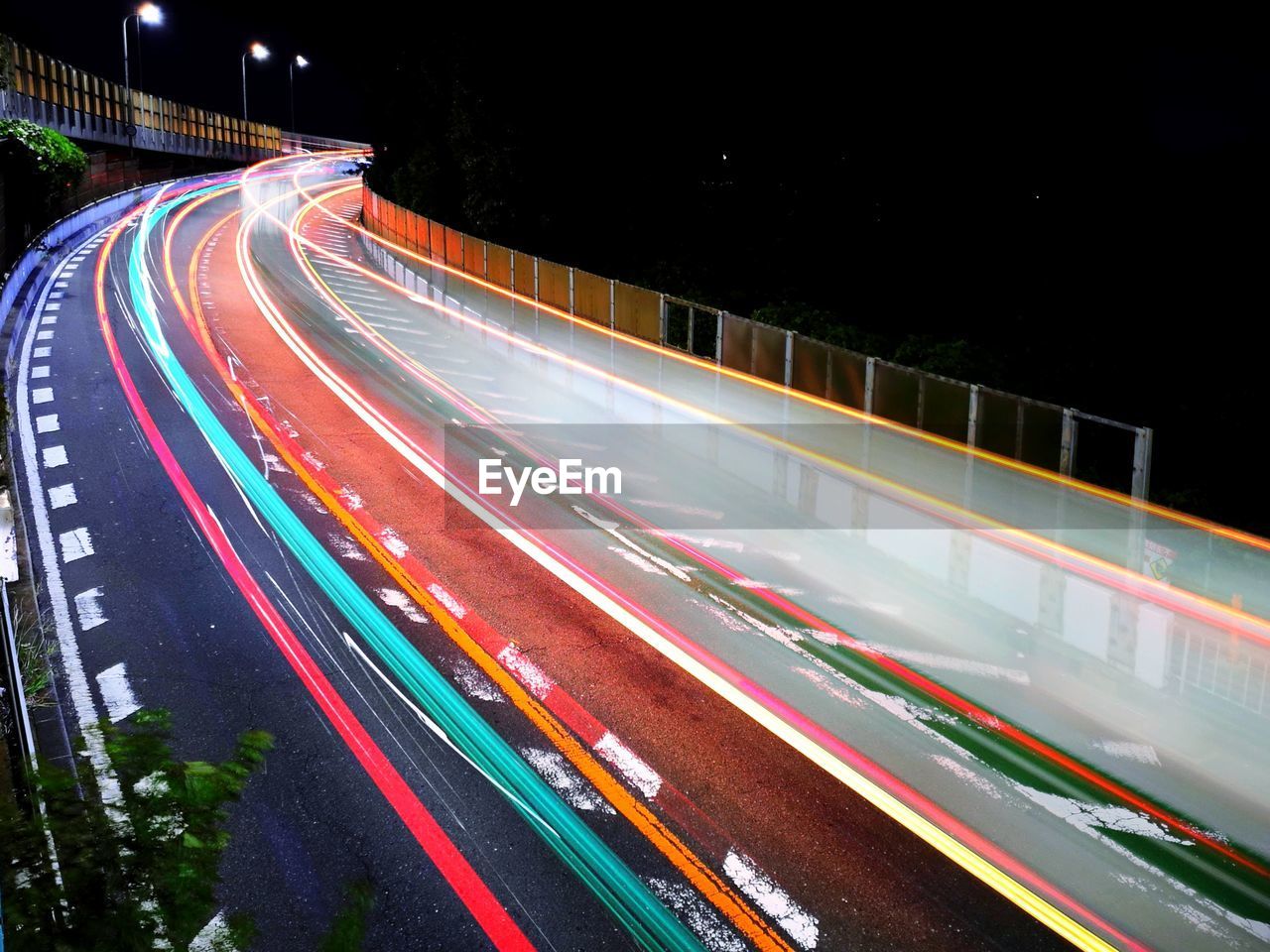 light trail, long exposure, speed, night, motion, transportation, illuminated, road, traffic, architecture, city, blurred motion, tail light, street, highway, light, mode of transportation, built structure, no people, city life, building exterior, motor vehicle, multi colored, car, city street, high angle view, street light, lighting equipment, lane, outdoors, light - natural phenomenon, infrastructure, on the move, metropolitan area, nature, vehicle, headlight, travel destinations