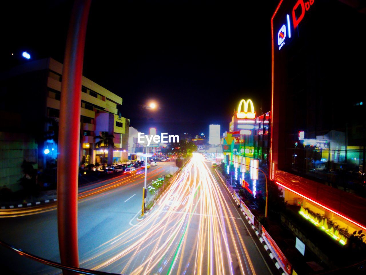 LIGHT TRAILS ON ROAD ALONG BUILDINGS