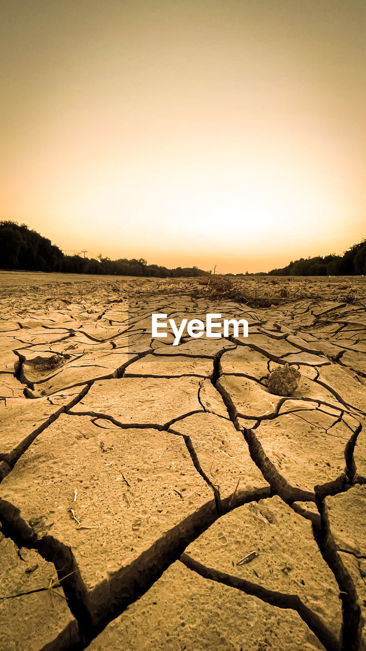 SURFACE LEVEL OF BARREN LANDSCAPE AGAINST SKY