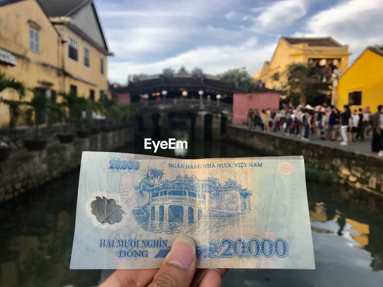 LOW SECTION OF PERSON HOLDING TEXT IN CITY