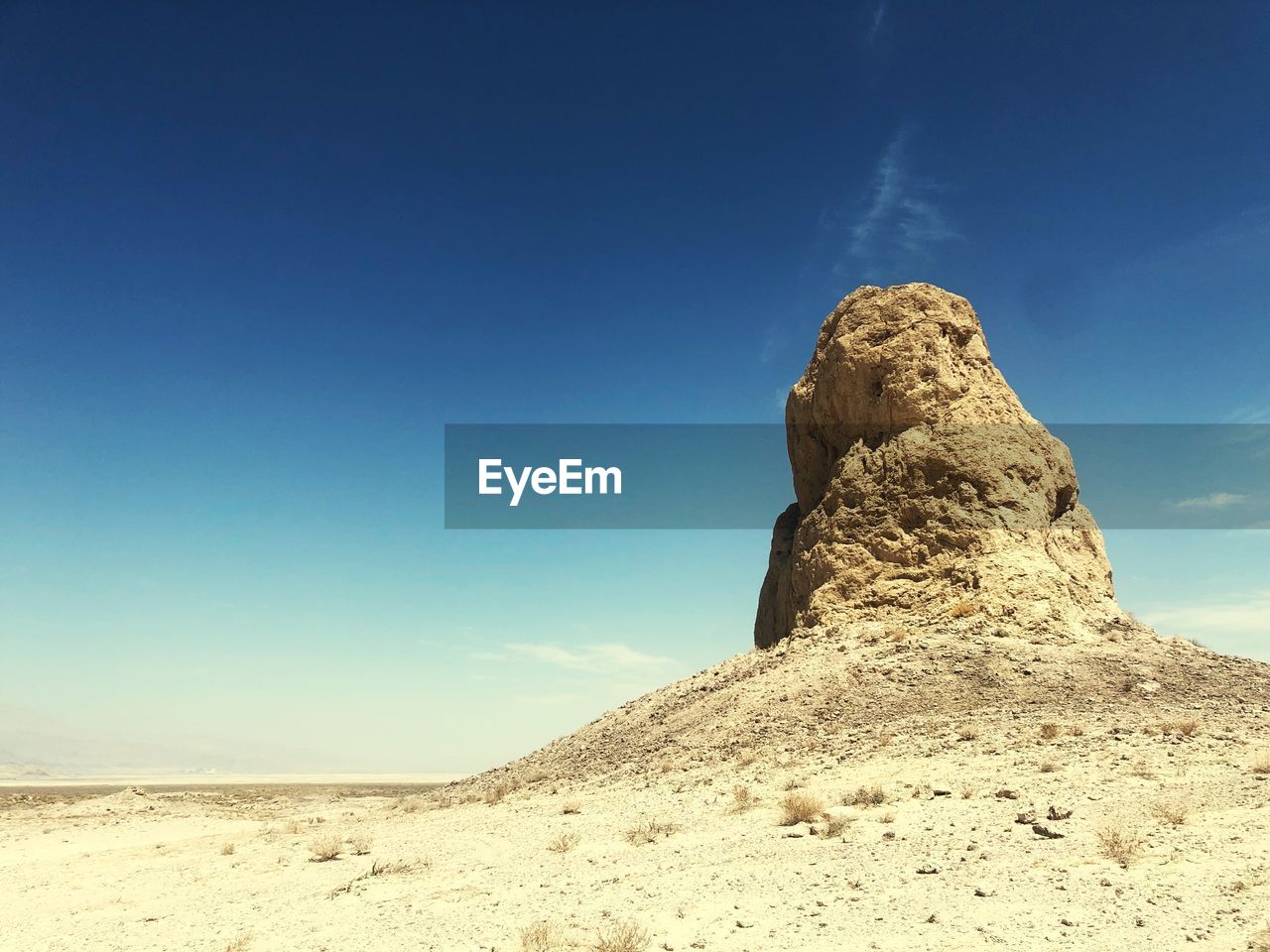 Low angle view of rock formations in desert against blue sky