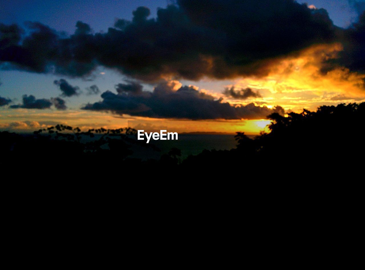 SCENIC VIEW OF DRAMATIC SKY OVER SILHOUETTE LANDSCAPE