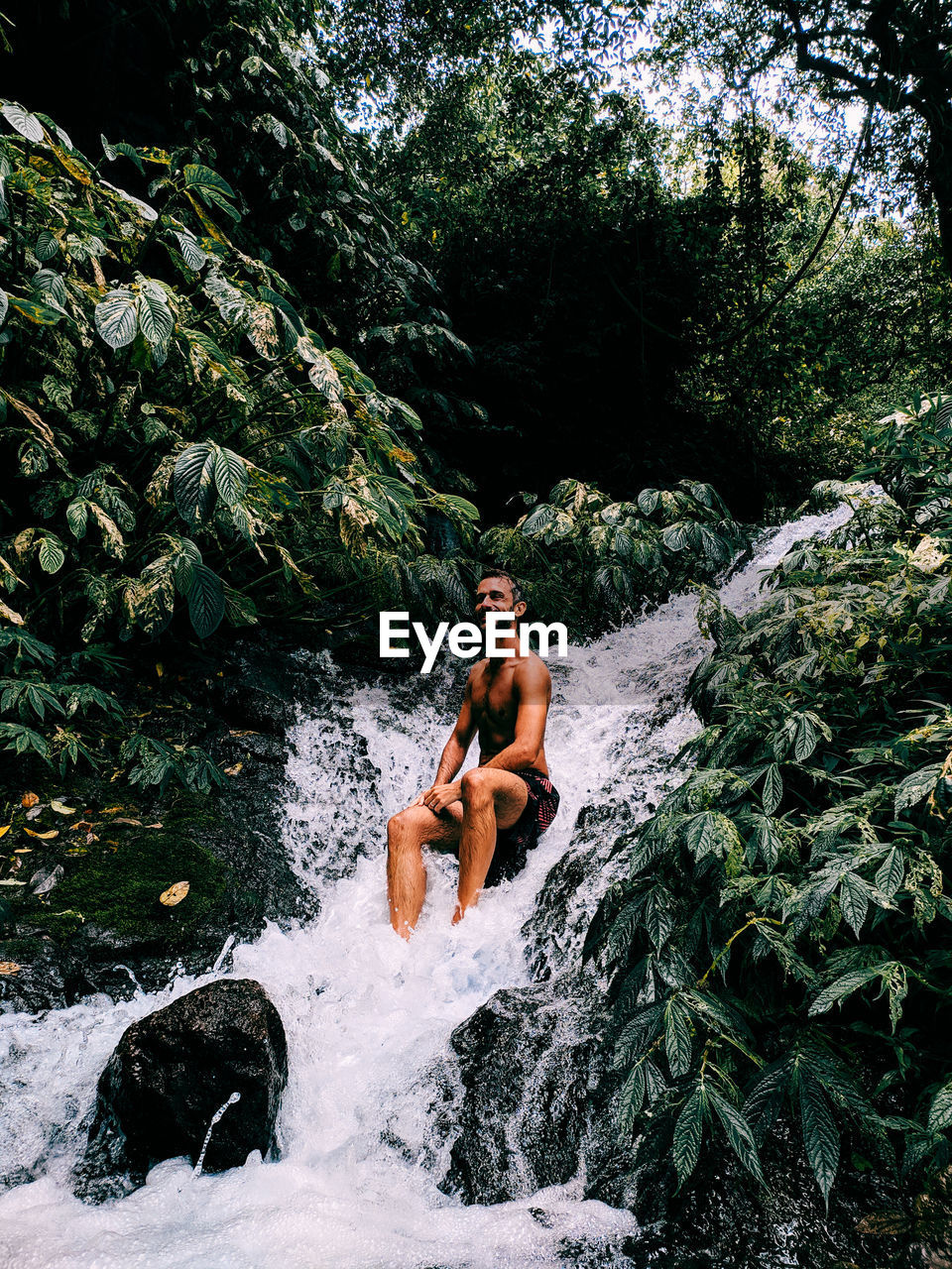 YOUNG MAN AND WOMAN IN RIVER