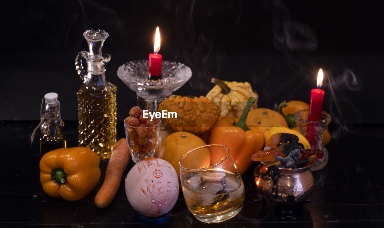 Close-up of lit candles on table, halloween concept