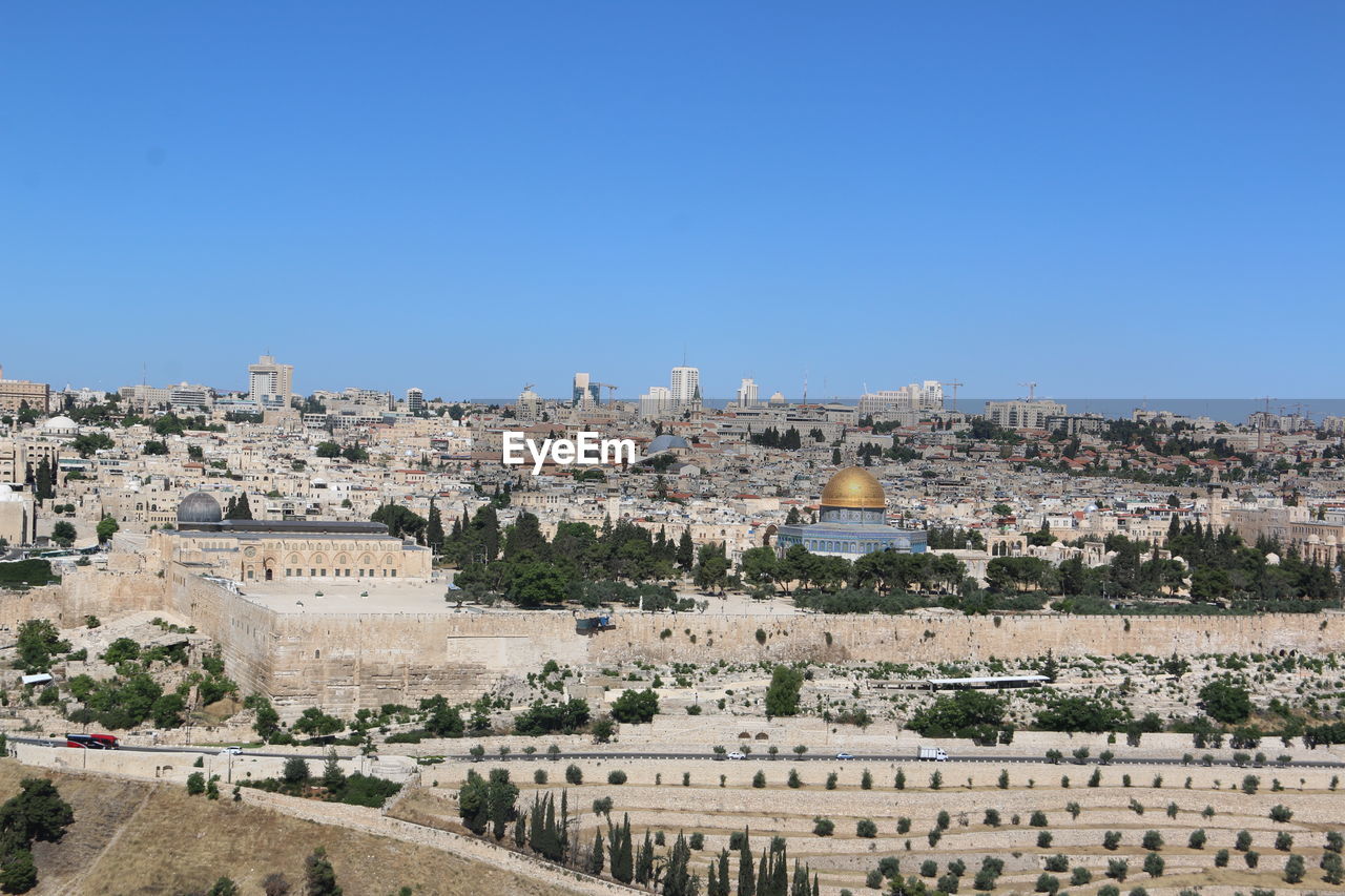 PANORAMIC VIEW OF BUILDINGS AGAINST BLUE SKY