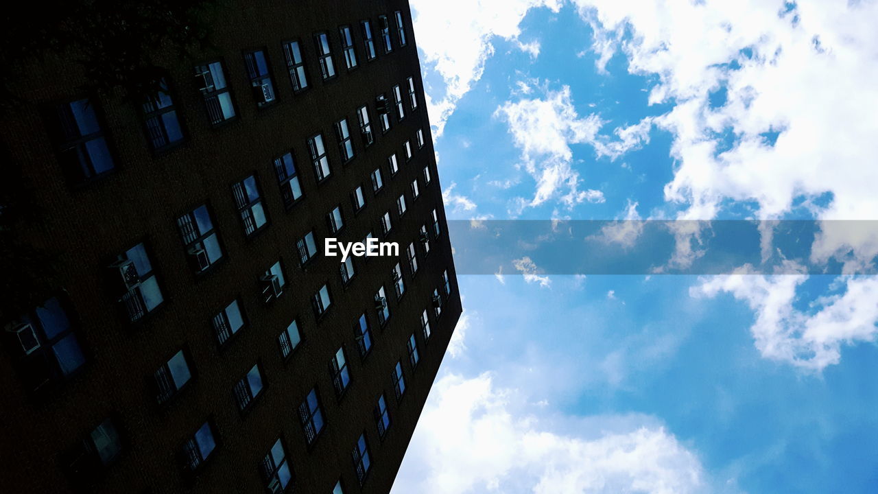 Low angle view of tall building against sky