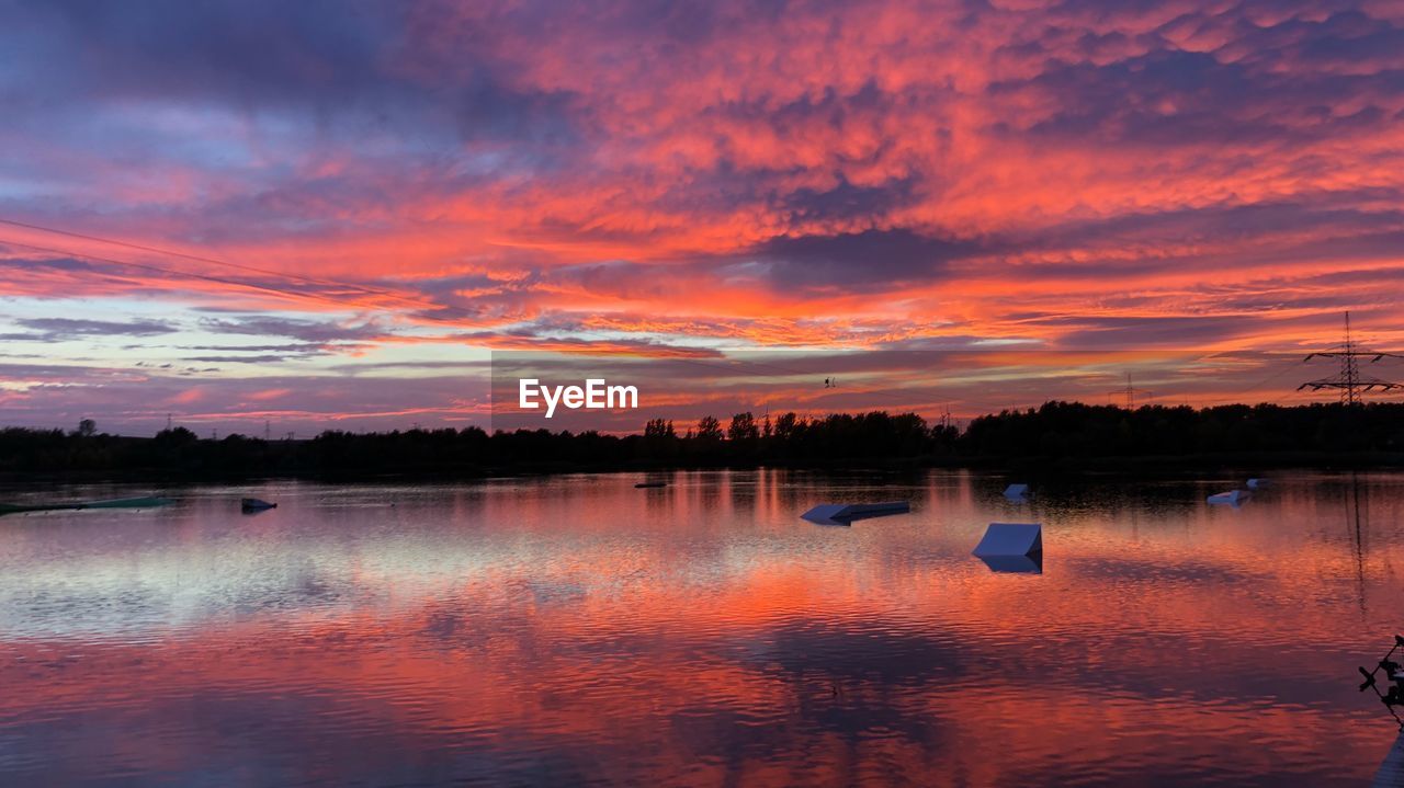 Scenic view of lake against orange sky