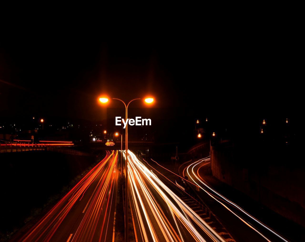 High angle view of light trails on highway at night