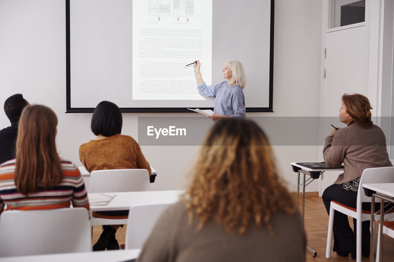 Woman giving presentation at seminar