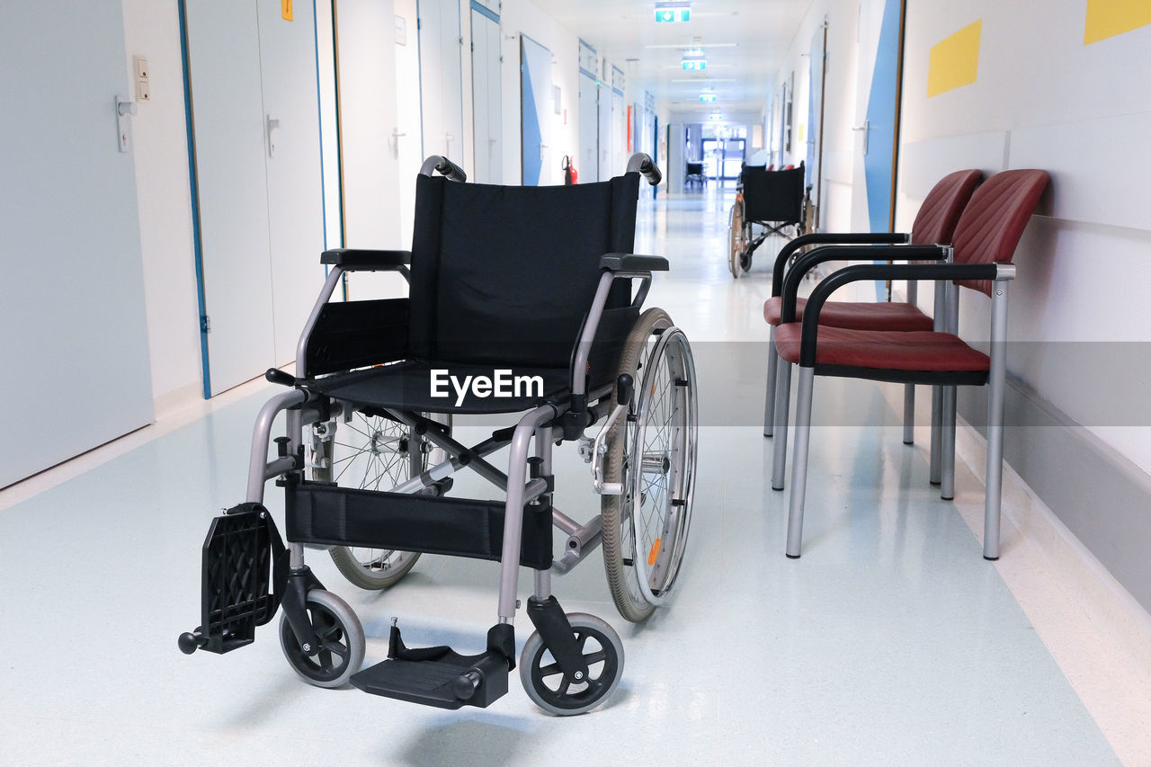 Wheelchair in an empty hospital corridor, close up. medical healthcare concept