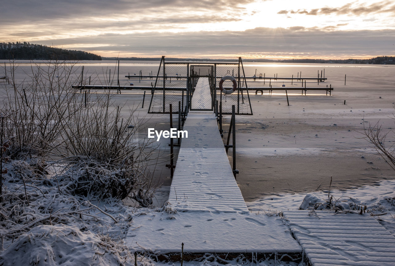 Scenic view of beach against sky during sunset