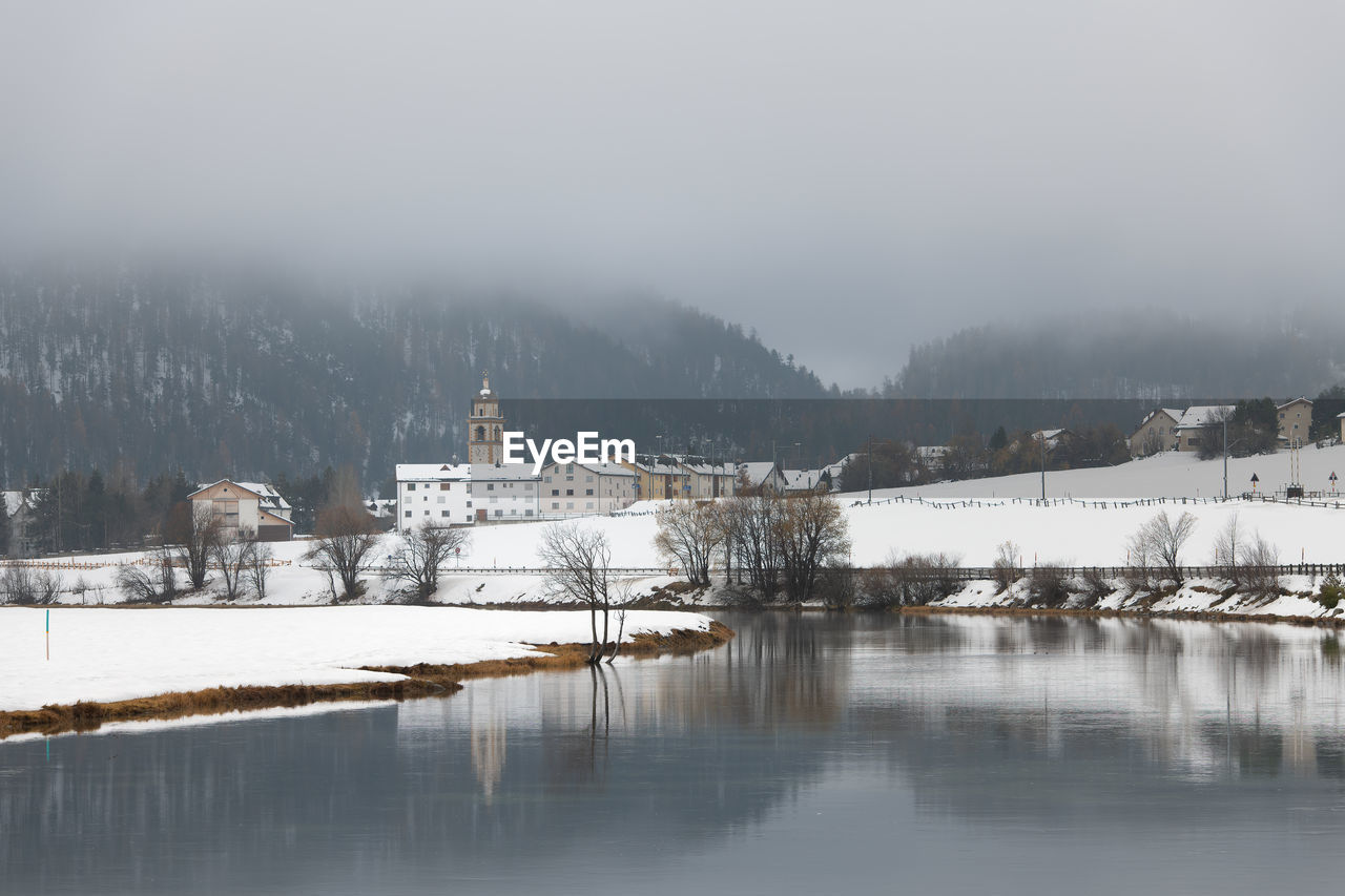 SCENIC VIEW OF BUILDING BY SNOW AGAINST SKY