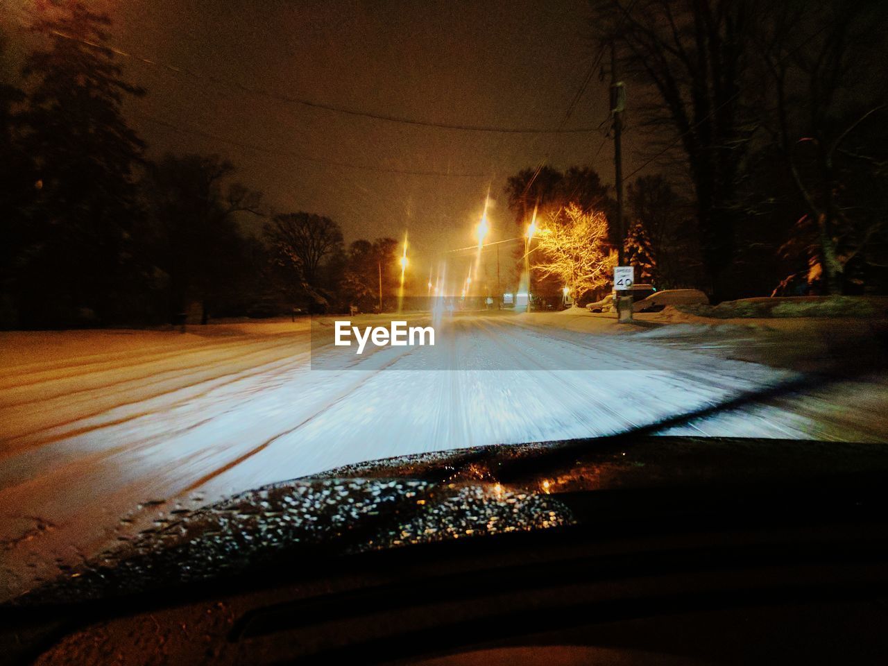 VIEW OF CAR ON ROAD AT NIGHT