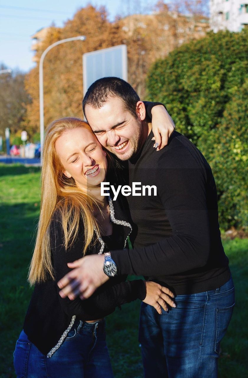 Happy couple standing at park