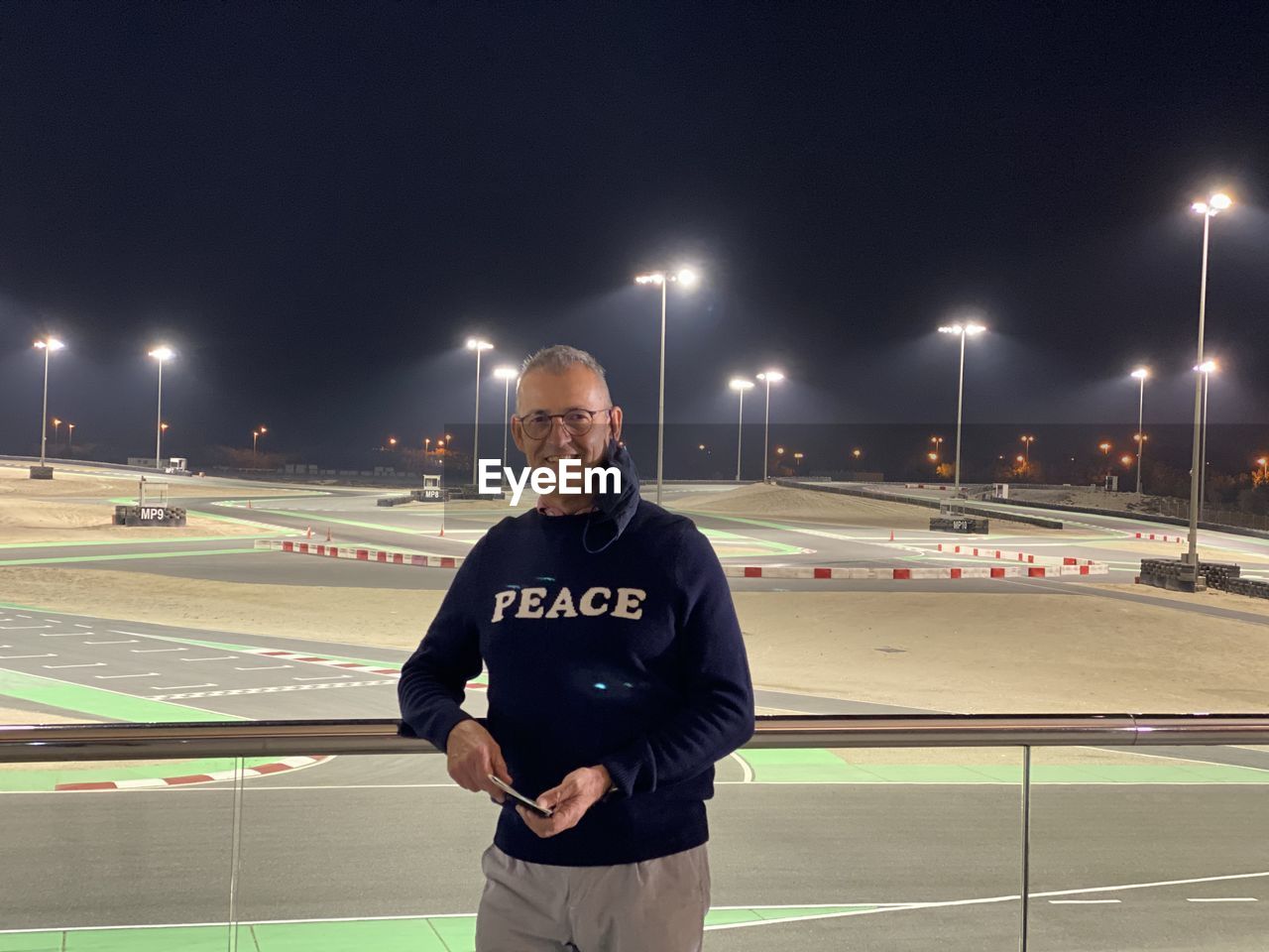 Portrait of smiling man about to go kart at the bahrain go karting track.