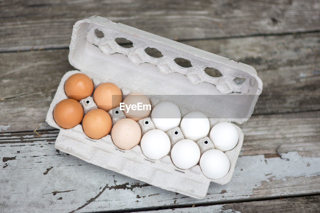 High angle view of eggs in carton on table