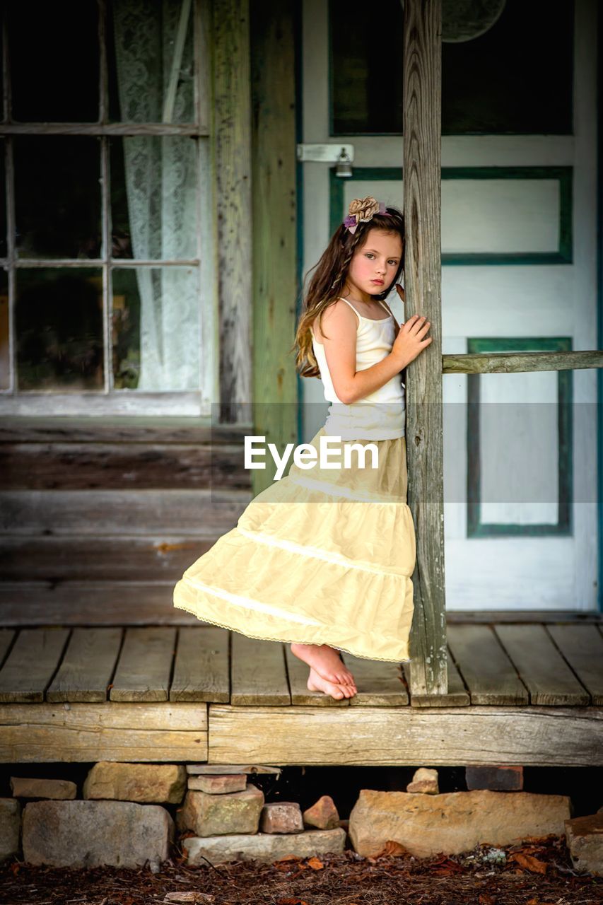 portrait of young woman standing on steps