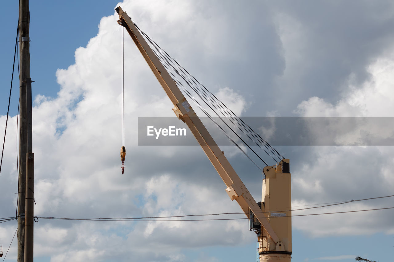 cloud, sky, mast, industry, crane - construction machinery, machinery, nature, construction industry, low angle view, architecture, day, construction site, vehicle, business, overhead power line, outdoors, transportation, no people, electricity, working, construction equipment, equipment, built structure, development, occupation