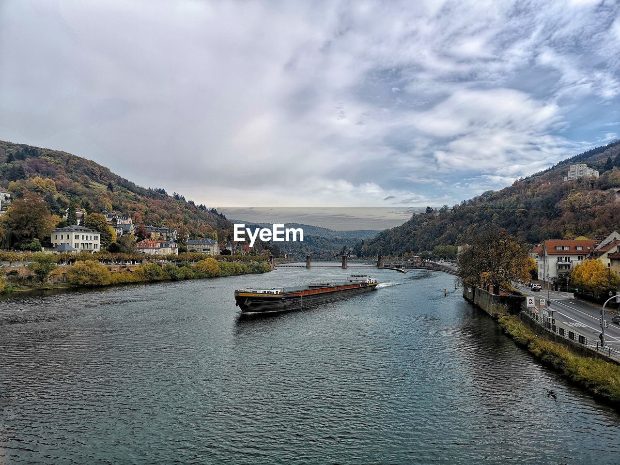 Scenic view of river by city against sky