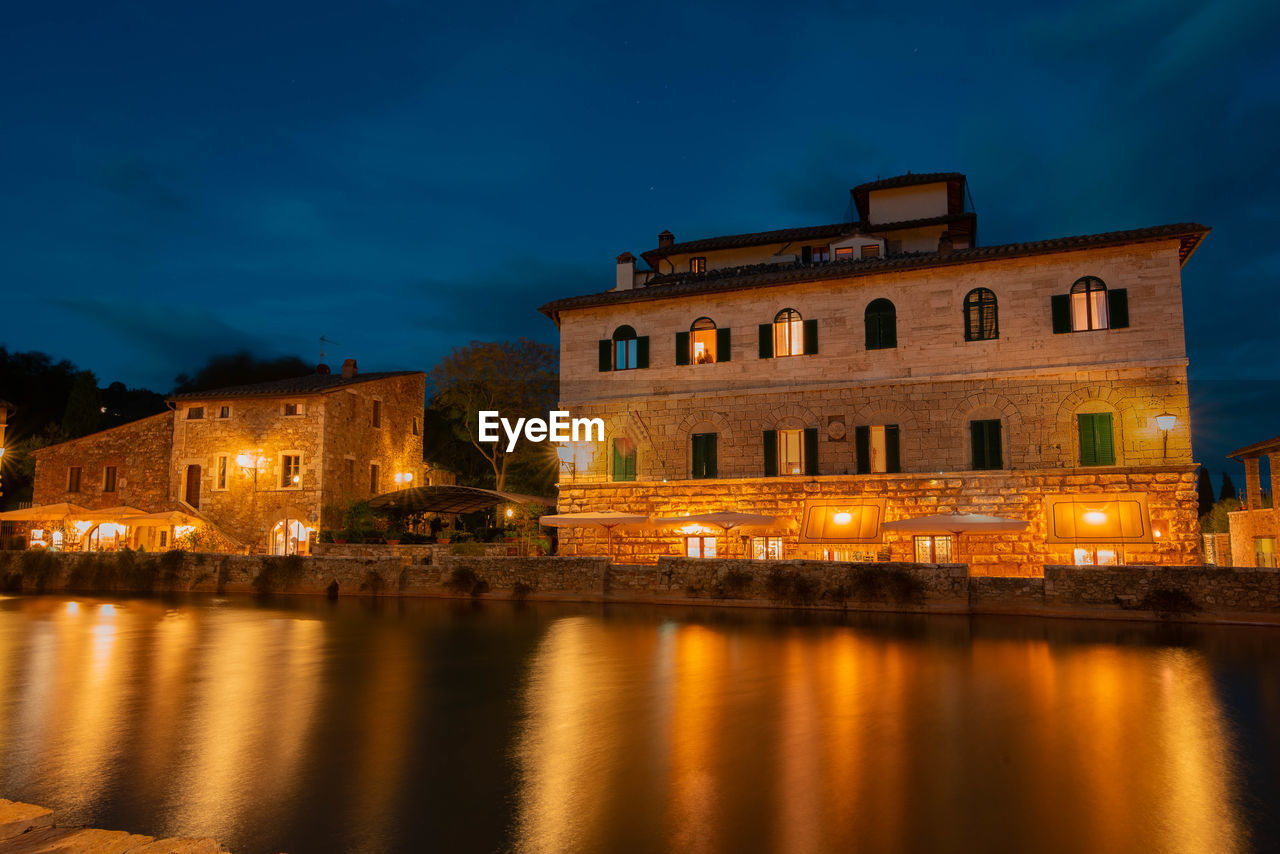 REFLECTION OF ILLUMINATED BUILDINGS IN WATER