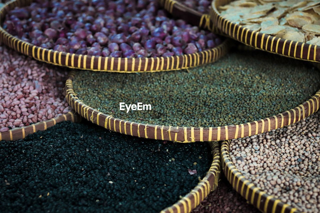 Close-up of multi colored food in wicker baskets at market