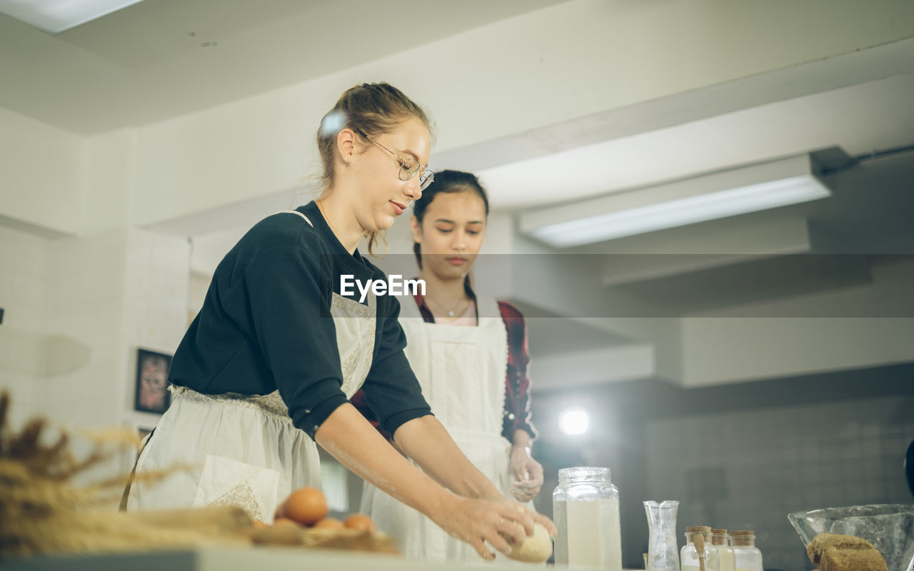 Two females make bakery in the kitchen