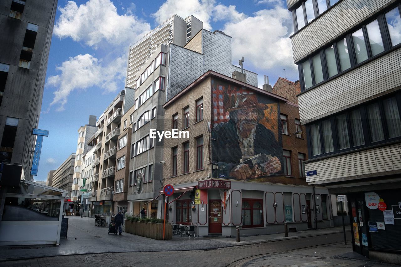 STREET AMIDST BUILDINGS AGAINST SKY