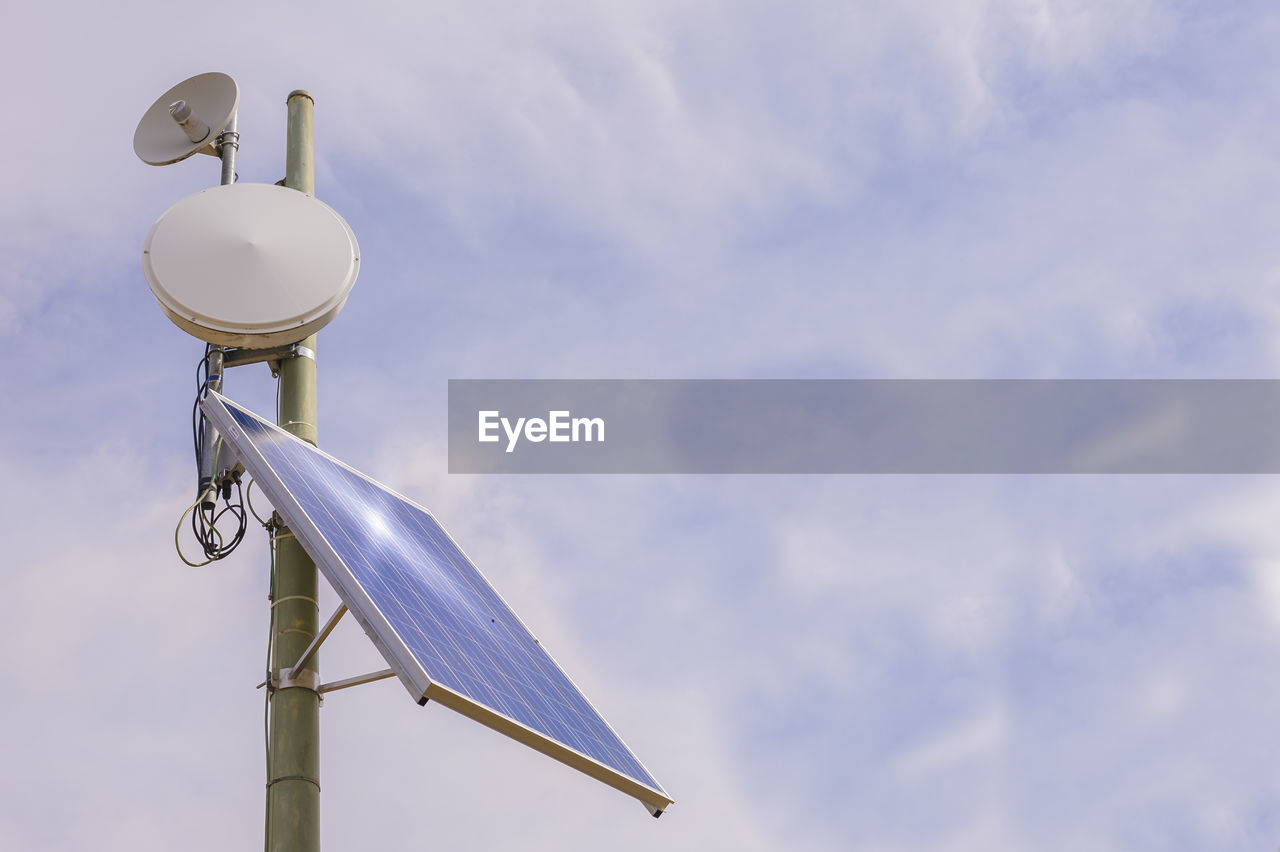 Low angle view of solar panels against sky