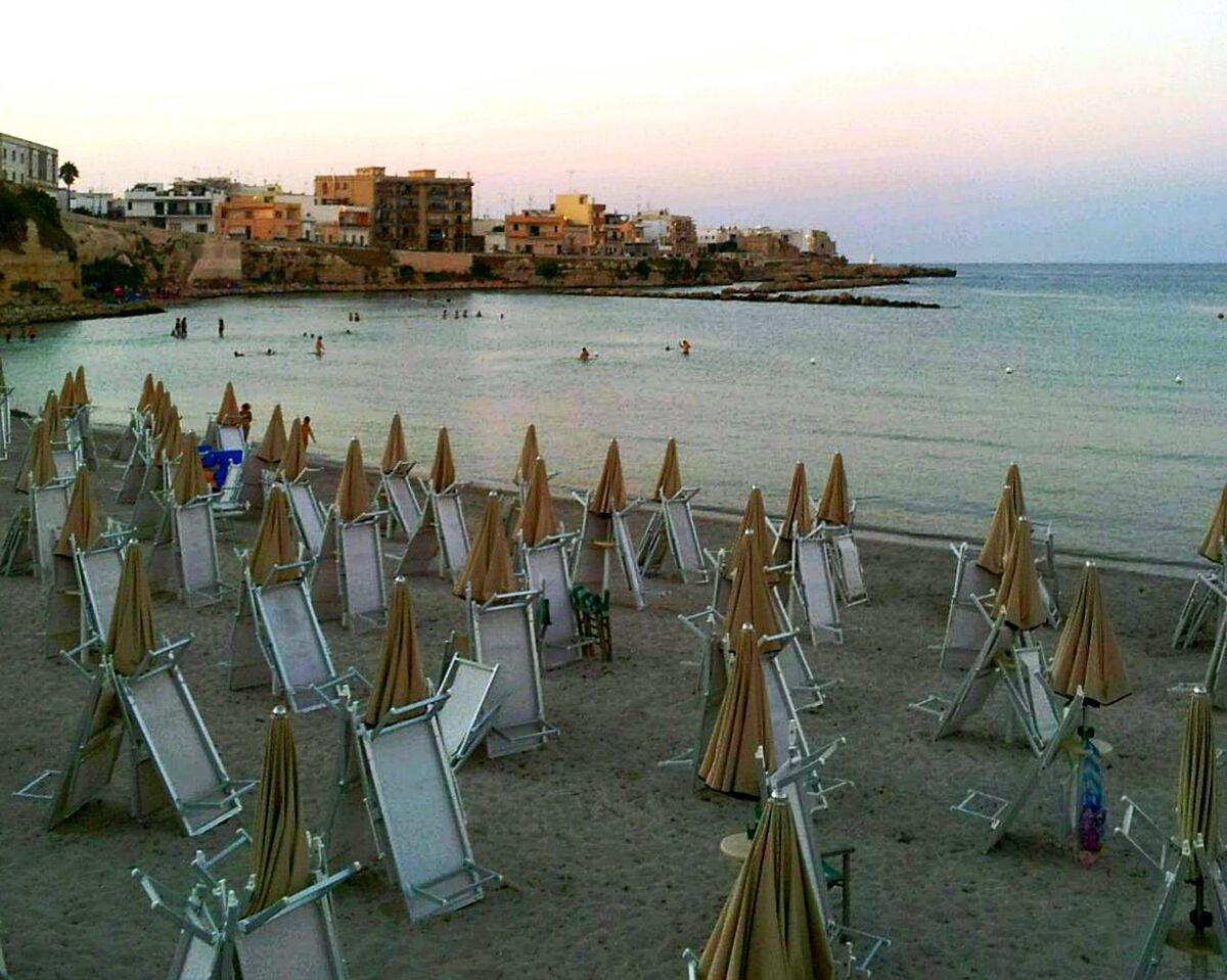 VIEW OF CALM BEACH AGAINST CLOUDY SKY