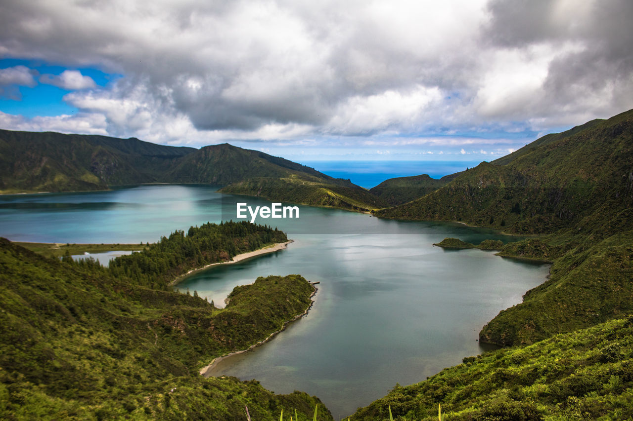 Scenic view of lake and mountains against sky